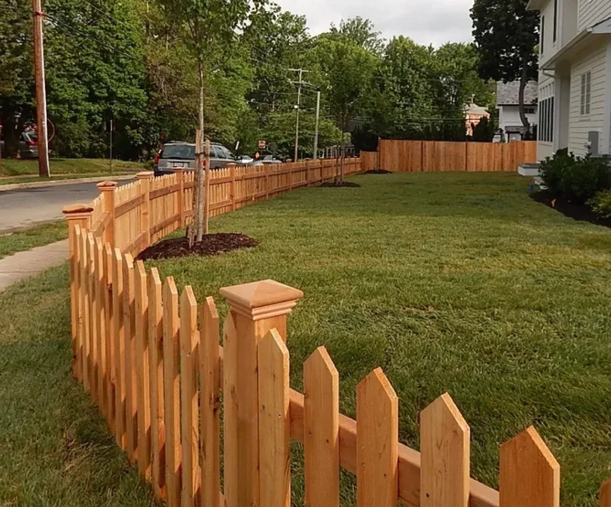 Wooden fence surrounding grassy yard